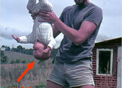 David Holding baby Luke upside down