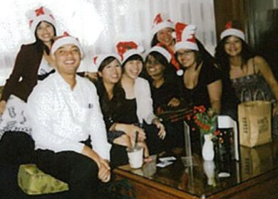 Hoffman employees at Holiday party wearing Santa hats