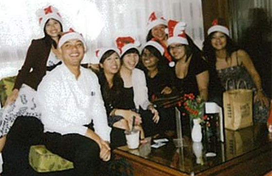 Hoffman employees at Holiday party wearing Santa hats