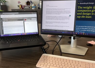 Desk with monitor, laptop and keyboard setup